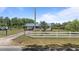 Well-manicured front yard with a white picket fence leads to a cozy home featuring a metal roof at 8163 Julian Rd, Dunn, NC 28334