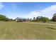 View of the property's expansive front yard and home featuring a metal roof at 8163 Julian Rd, Dunn, NC 28334