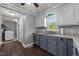 Galley kitchen features gray lower cabinets, white upper cabinets, with modern appliances at 8163 Julian Rd, Dunn, NC 28334