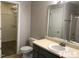Bathroom featuring a vanity, mirror, toilet, and view into the walk-in closet and shower at 8908 Shallcross Way, Raleigh, NC 27617