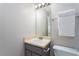 Well-lit bathroom with a vanity, mirror, and modern fixtures, complemented by a white towel at 8908 Shallcross Way, Raleigh, NC 27617