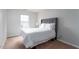 Bright bedroom featuring a queen-sized bed, neutral carpet, and a window with natural light at 8908 Shallcross Way, Raleigh, NC 27617