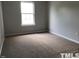 Neutral bedroom with carpet and a window providing natural light, creating a serene space at 8908 Shallcross Way, Raleigh, NC 27617