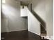 Bright and airy living room with stairs and dark flooring, showcasing a modern aesthetic at 8908 Shallcross Way, Raleigh, NC 27617