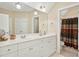 Bathroom featuring double vanity, neutral walls, and a shower at 10011 Hammock Bnd, Chapel Hill, NC 27517