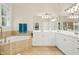 Bathroom showcasing tiled corner tub, white cabinets, and dual sinks at 10011 Hammock Bnd, Chapel Hill, NC 27517