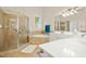 Bathroom with glass shower, corner tub, and dual sinks at 10011 Hammock Bnd, Chapel Hill, NC 27517