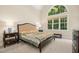 Bright bedroom features a large window and decorative bedframe at 10011 Hammock Bnd, Chapel Hill, NC 27517