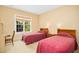 Bedroom features twin beds, neutral carpet, and natural light at 10011 Hammock Bnd, Chapel Hill, NC 27517
