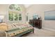 Bedroom featuring large window and dresser with television on top at 10011 Hammock Bnd, Chapel Hill, NC 27517