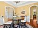 Dining room with chandelier, table, and archway to other rooms, creating a sophisticated atmosphere at 10011 Hammock Bnd, Chapel Hill, NC 27517