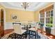 Bright dining room features a round table, four chairs, a large window, and beautiful hardwood floors at 10011 Hammock Bnd, Chapel Hill, NC 27517
