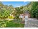 Brick home featuring an attached garage, driveway and well-maintained landscaping, enhancing the property's appeal at 10011 Hammock Bnd, Chapel Hill, NC 27517