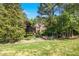 Beautiful brick home nestled among mature trees and lush landscaping offers privacy and curb appeal at 10011 Hammock Bnd, Chapel Hill, NC 27517