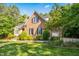 Charming brick home with lush landscaping, providing a serene and private outdoor space at 10011 Hammock Bnd, Chapel Hill, NC 27517