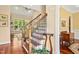 Elegant foyer with staircase and wood floors, seamlessly connecting living spaces and offering a warm welcome at 10011 Hammock Bnd, Chapel Hill, NC 27517