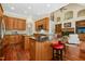 Open-concept kitchen with hardwood floors, granite countertops, stainless appliances, and breakfast bar seating at 10011 Hammock Bnd, Chapel Hill, NC 27517