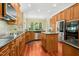 Spacious kitchen with stainless steel appliances, wooden cabinets, granite countertops and hardwood floors at 10011 Hammock Bnd, Chapel Hill, NC 27517