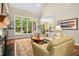 Comfortable living room featuring a large window, a fireplace, hardwood floors, and neutral-toned furnishings at 10011 Hammock Bnd, Chapel Hill, NC 27517