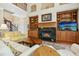 Inviting living room features a fireplace with custom built-ins, plush seating, and a view of the staircase at 10011 Hammock Bnd, Chapel Hill, NC 27517