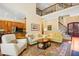 Spacious living room with multiple seating areas, a staircase, hardwood floors, and abundant natural light at 10011 Hammock Bnd, Chapel Hill, NC 27517