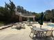 Outdoor community pool area featuring a clubhouse, umbrellas, and tables at 10011 Hammock Bnd, Chapel Hill, NC 27517