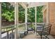 Relaxing screened porch offering views of lush greenery and a peaceful setting at 10011 Hammock Bnd, Chapel Hill, NC 27517