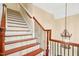 Beautiful staircase features wood treads, white risers, and decorative railing at 10011 Hammock Bnd, Chapel Hill, NC 27517