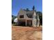 New construction exterior featuring white brick, gray siding, an attached two-car garage, and a modern architectural style at 1002 Canterbury Rd, Raleigh, NC 27607
