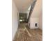Bright foyer with beautiful hardwood flooring and a staircase with black metal railings at 1002 Canterbury Rd, Raleigh, NC 27607