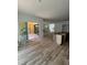 Spacious kitchen with white cabinets, a wooden island frame, hardwood flooring, and access to the outdoor patio at 1002 Canterbury Rd, Raleigh, NC 27607