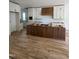 Spacious kitchen with white cabinetry, a dark wood island, and hardwood flooring at 1002 Canterbury Rd, Raleigh, NC 27607
