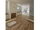 Open-concept living room with hardwood floors, white cabinetry, and a staircase at 1002 Canterbury Rd, Raleigh, NC 27607