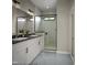 Bathroom with a double sink vanity, quartz countertops, large mirror, and a glass-enclosed walk-in shower at 1036 Harper Rd, Raleigh, NC 27603