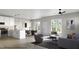 Bright open-concept living area featuring hardwood floors, recessed lighting, and a view to the outside at 1036 Harper Rd, Raleigh, NC 27603