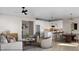 Open-concept living room and kitchen with hardwood floors, stainless steel appliances, and white cabinetry at 1036 Harper Rd, Raleigh, NC 27603