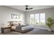 Cozy main bedroom with three windows, neutral walls, a ceiling fan and stylish decor at 1036 Harper Rd, Raleigh, NC 27603