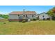 Spacious backyard featuring a deck, green lawn, and detached garage at 109 N Valley Dr, Louisburg, NC 27549