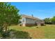 Backyard view showcases the deck, lawn, and home's exterior at 109 N Valley Dr, Louisburg, NC 27549