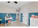 Charming bedroom with half painted colorful walls, a vanity and bright natural lighting at 109 N Valley Dr, Louisburg, NC 27549