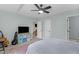 Cozy bedroom with a ceiling fan, neutral carpet, and a view out the window at 109 N Valley Dr, Louisburg, NC 27549