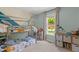 Bright bedroom featuring a bunk bed, cube storage, and window with outdoor view at 109 N Valley Dr, Louisburg, NC 27549