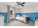 A cheerful bedroom features a large window, neutral carpeting and half painted colorful walls at 109 N Valley Dr, Louisburg, NC 27549