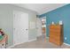 Neutral-toned bedroom showcasing closet space and doorway leading into another room at 109 N Valley Dr, Louisburg, NC 27549