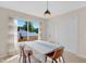 Cozy dining room with a large window letting in plenty of natural light, set for six at 109 N Valley Dr, Louisburg, NC 27549