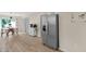 Modern kitchen features wood floors, stainless steel refrigerator, and a dining area at 109 N Valley Dr, Louisburg, NC 27549