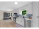 Bright kitchen with stainless appliances, white cabinets, light countertops and a view to the backyard at 109 N Valley Dr, Louisburg, NC 27549