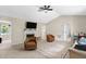 Bright living room featuring a fireplace, ceiling fan, and neutral color palette at 109 N Valley Dr, Louisburg, NC 27549