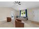Cozy living room featuring plush seating, a ceiling fan, and natural light at 109 N Valley Dr, Louisburg, NC 27549