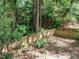 View of secluded backyard featuring lush greenery and a wooden fence for privacy at 112 Cameron Ct, Cary, NC 27511